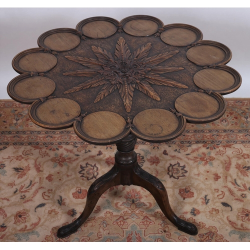 85 - A 19TH CENTURY CARVED MAHOGANY SNAP TOP OCCASIONAL TABLE the shaped top centred by foliate carved pa... 