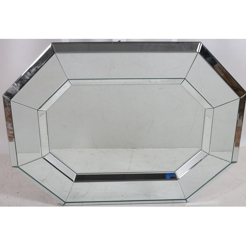 854 - A CONTEMPORARY MIRROR OF OCTAGONAL OUTLINE the shaped bevelled glass plate and marginal mirrored fra... 