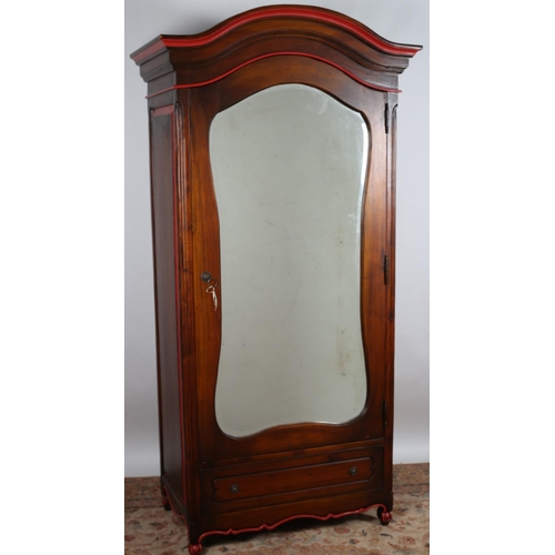 86 - A BIEDERMEIER DESIGN WALNUT WARDROBE the arched cornice above a bevelled glass mirrored door contain... 