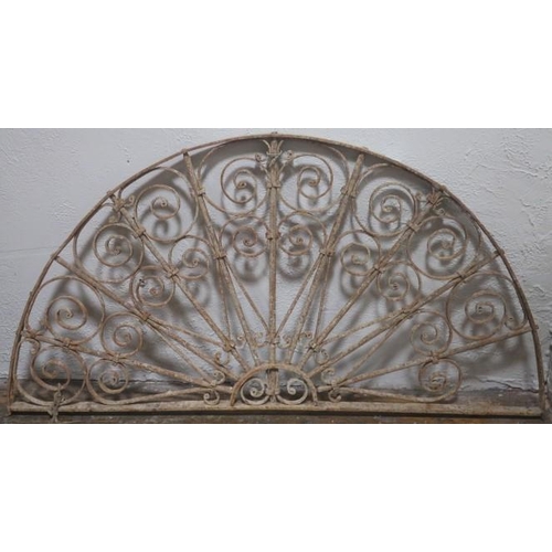 854 - A 19TH CENTURY WROUGHT IRON FAN LIGHT of demi lune outline with scroll decoration 
72cm (h) x 139cm ... 