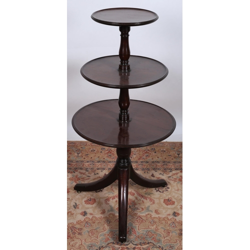 78 - A GEORGIAN MAHOGANY THREE TIER DUMBWAITER each circular dish shaped graduated shelf joined by balust... 