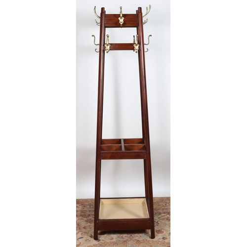 101 - A VINTAGE MAHOGANY HAT COAT AND STICK STAND of rectangular spreading form with twelve brass hooks ab... 