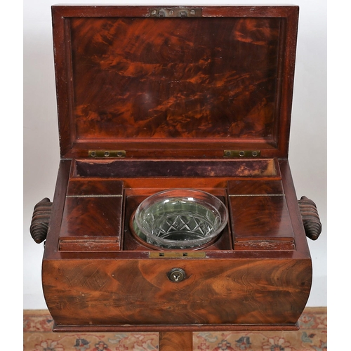 102 - A 19TH CENTURY MAHOGANY TEAPOY of sarcophagus outline the raised moulded hinged lid containing lidde... 