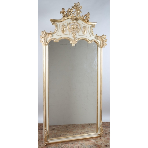 110 - A CONTINENTAL GILT FRAME AND PAINTED MIRROR the rectangular bevelled glass shaped plate within a mou... 