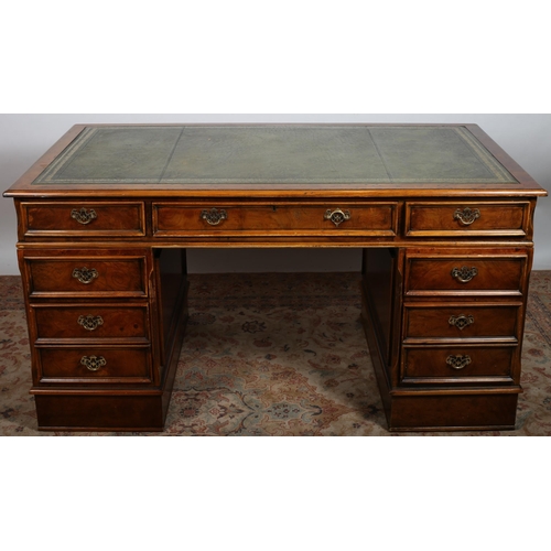 481 - A WALNUT PEDESTAL DESK of rectangular outline the shaped top with tooled leather inset above three f... 