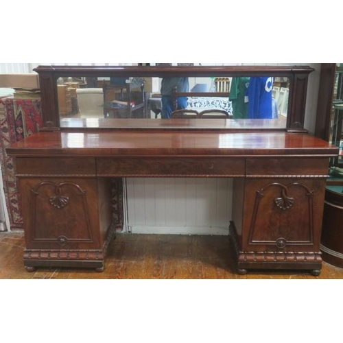 483 - A WILLIAM IV MAHOGANY PEDESTAL SIDEBOARD the rectangular top with mirrored back above three frieze d... 