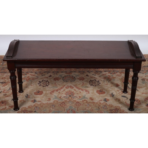 484 - A VINTAGE MAHOGANY STOOL the rectangular seat with shaped moulded ends on turned legs 
47cm (h) x 92... 