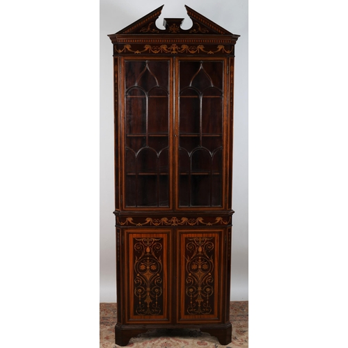 485 - AN EDWARD MAHOGANY AND SATINWOOD INLAID CORNER CABINET the architectural pediment above a pair of as... 