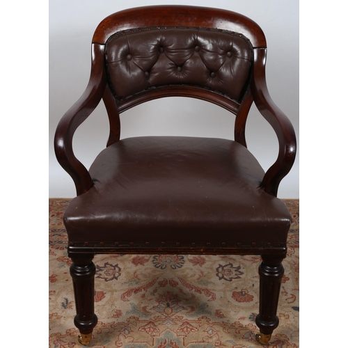 487 - A 19TH CENTURY MAHOGANY LIBRARY ARMCHAIR the curved top rail above a buttoned upholstered back and s... 