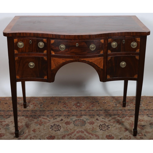 496 - A GEORGIAN MAHOGANY CROSSBANDED SIDEBOARD of serpentine outline, the shaped top above a frieze drawe... 