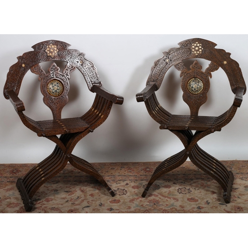 504 - A PAIR OF MOORISH CARVED WOOD FOLDING ARMCHAIRS with bone inlay the shaped arched back with pierced ... 