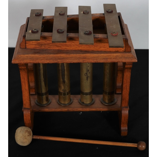 494 - A 19TH CENTURY FOUR NOTE VIBRAPHONE with vertical brass tubes in a carved oak frame with beater
26 c... 