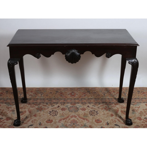 513 - AN IRISH DESIGN MAHOGANY SIDE TABLE of rectangular outline the shaped frieze with shell and flowerhe... 