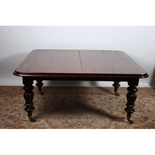 518 - A WILLIAM IV MAHOGANY TELESCOPIC DINING TABLE of rectangular outline with rounded corners and one lo... 