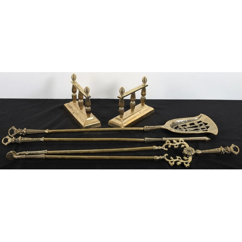 541 - A SET OF THREE BRASS FIRE IRONS comprising poker, shovel and tongs together with a pair of fire dogs... 