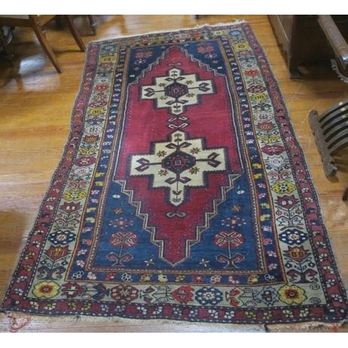 544 - A HAMADAN WOOL RUG the wine and indigo ground with central serrated panel filled with stylised flowe... 