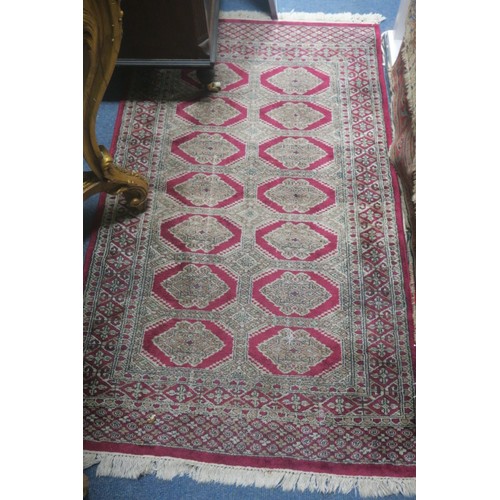 553 - A BAKHARA WOOL RUG the wine and cream ground with central diamond shaped panels filled with stylised... 