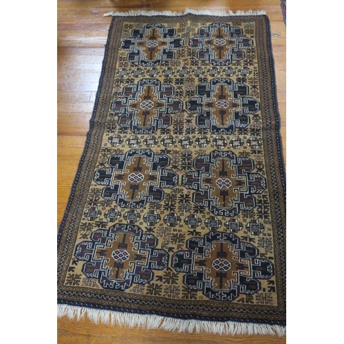 554 - AN ORIENTAL WOOL RUG the light brown ground with central panels of irregular outline filled with oct... 