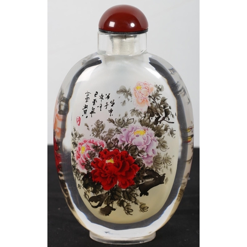 578 - A CHINESE PAINTED GLASS SNUFF BOTTLE of flask form decorated with floral bouquet signed and inscribe... 