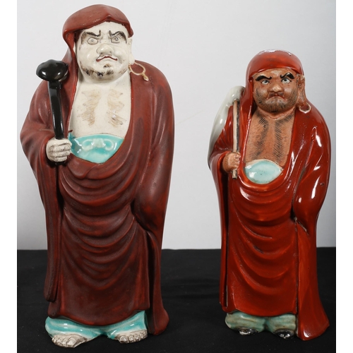 584 - A JAPANESE PORCELAIN FIGURE OF DARUMA 
21 cm (h) together with a larger example 25 cm (h)