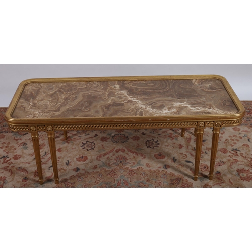 706 - A CONTINENTAL GILTWOOD COFFEE TABLE of rectangular outline surmounted by an oynx inset above a scrol... 