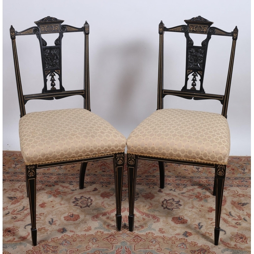 708 - A PAIR OF VINTAGE EBONISED AND PARCEL GILT SIDE CHAIRS each with a pierced carved vertical splat wit... 