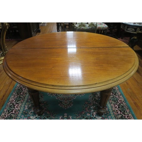 722 - A 19TH CENTURY MAHOGANY TELESCOPIC DINING TABLE of oval outline the shaped top with one loose leaf o... 