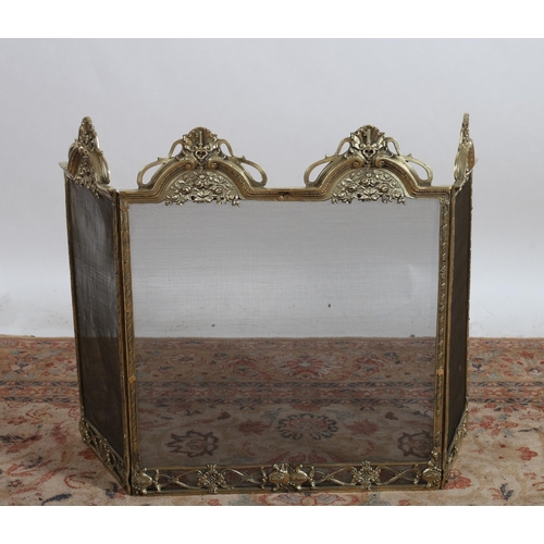 730 - A CONTINENTAL GILT BRASS AND MESH THREEFOLD FOLDING SCREEN THE arched cresting, with shell flowerhea... 