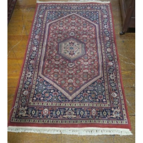 733 - A BAKHARA WOOL RUG the wine and indigo ground with central diamond shaped panel filled with stylised... 