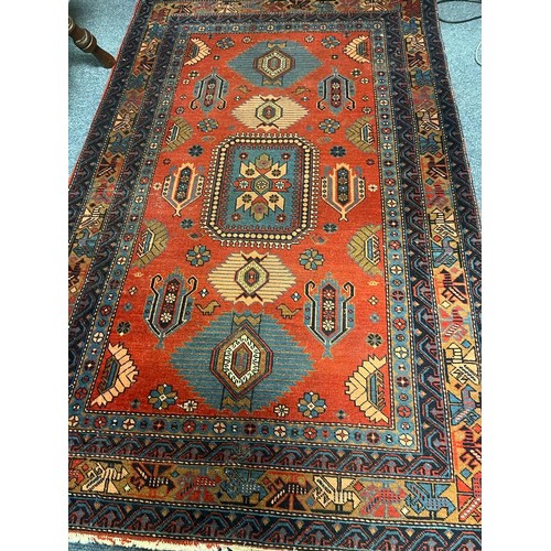 737 - A TABRIZ WOOL RUG the light red light blue ground with central panel filled with serrated hooks and ... 