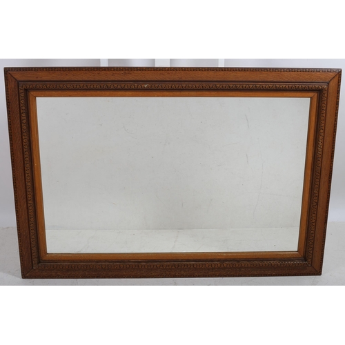 757 - AN OAK FRAME MIRROR THE RECTANGULAR PLATE within a carved and moulded frame 
134 cm (h) x 92 cm (w)