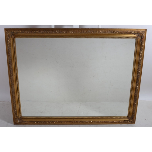 761 - A GILT FRAME MIRROR WITH RECTANGULAR BEVEL GLASS PLATE with bead work and foliate moulded frame
111 ... 