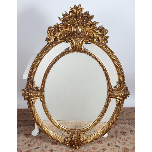 908 - A CONTINENTAL GILT FRAME COMPARTMENTED MIRROR the oval bevelled glass plates within beadwork and flo... 