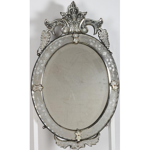 909 - A 19TH CENTURY VENETIAN MIRROR the oval bevelled glass plate within an etched glass frame with c-scr... 