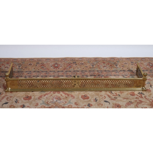 916 - A BRASS FENDER the pierced frieze above a stepped base with ball finials 
14cm (h) x 124cm (w) x 34c... 