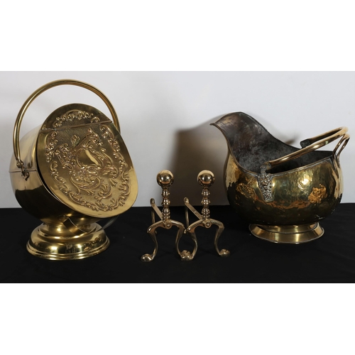 114 - A BRASS SWING HANDLE COAL SCUTTLE with embossed hinged lid above a circular spreading foot together ... 