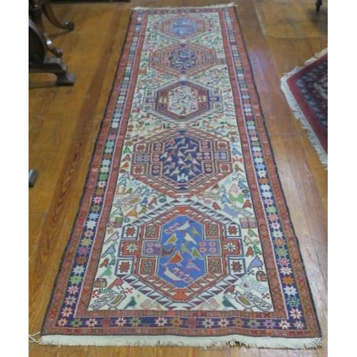 546 - AN ORIENTAL WOOL RUG the cream and indigo ground with central serrated panels filled with animals wi... 