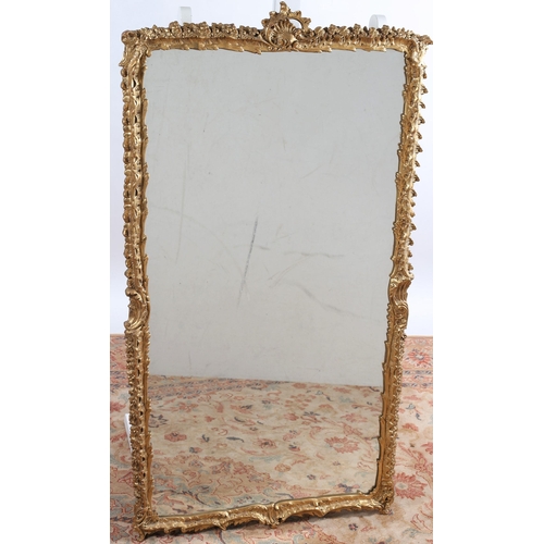 573 - A CONTINENTAL GILT FRAME MIRROR the rectangular plate within a foliate and C-scroll frame with pierc... 