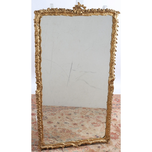 574 - A CONTINENTAL GILT FRAME MIRROR the rectangular plate within a foliate and C-scroll frame with pierc... 