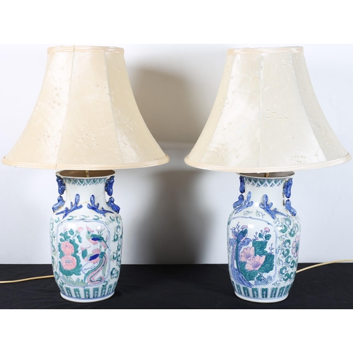 619 - A PAIR OF PORCELAIN TABLE LAMPS each of vase form decorated in the Chinese taste with needlework sha... 