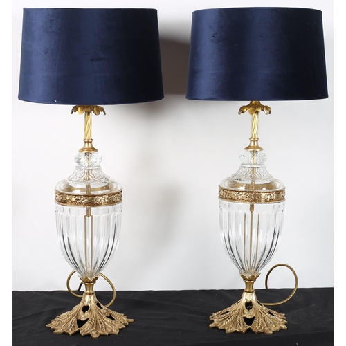 621 - A PAIR OF CONTINENTAL CUT GLASS AND GILT BRASS TABLE LAMPS each of urn form with foliate gilt brass ... 