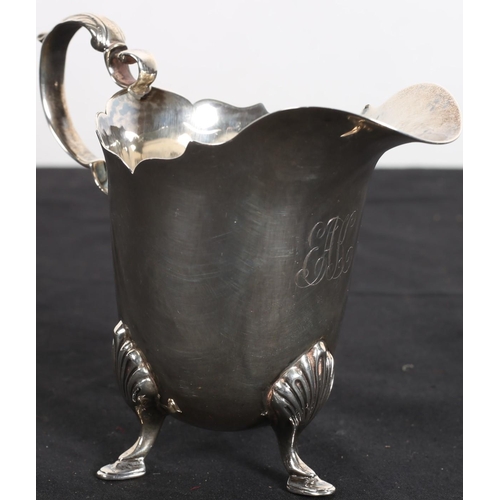 634 - A SILVER CREAM JUG with scroll handle on pad feet 
Dublin 1918