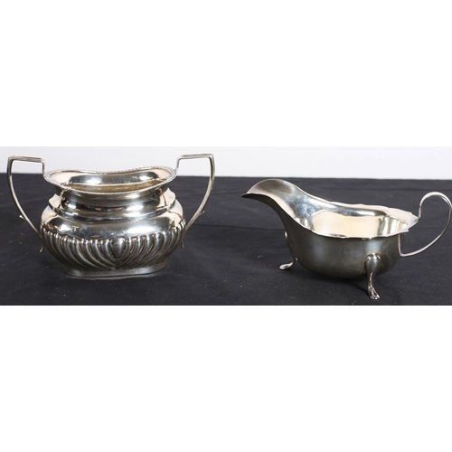 635 - A SILVER TWO HANDLE SUGAR BOWL together with a silver sauce boat