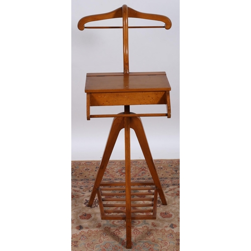 65 - A VINTAGE BEECHWOOD VALET with hinged compartment above a hanging rail on triform base joined by a s... 