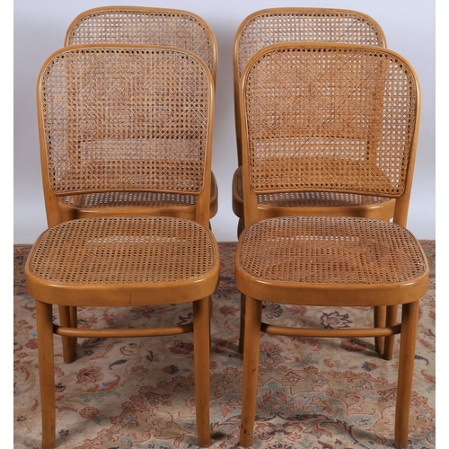 666 - A SET OF FOUR BENTWOOD AND CANED CHAIRS each with a curved top rail with caned panel and seat on cyl... 