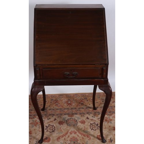 671 - A VINTAGE MAHOGANY BUREAU the rectangular top above a hinged slope containing pigeon holes and drawe... 