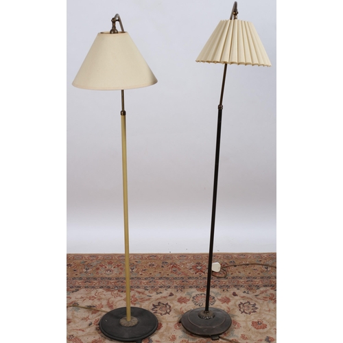 676 - TWO VINTAGE BRASS WHITE PAINTED FLOOR STANDARD LAMPS with adjustable arms and shades raised on a cir... 