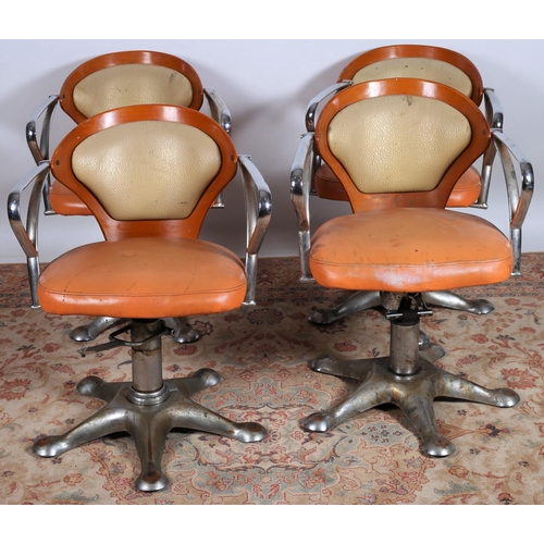 684 - A SET OF FOUR VINTAGE CHROME AND UPHOLSTERED TUB SHAPED BARBER'S CHAIRS each with a curved upholster... 