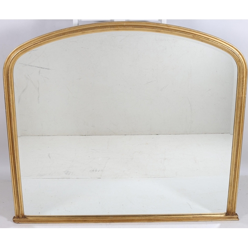 749 - A VICTORIAN DESIGN GILT FRAME OVERMANTLE MIRROR the rectangular arched bevelled glass plate within a... 