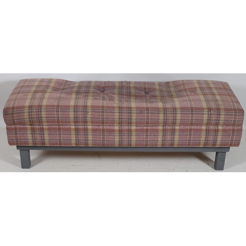 768 - A CONTEMPORARY GREY PAINTED AND UPHOLSTERED STOOL of rectangular outline the shaped buttoned upholst... 